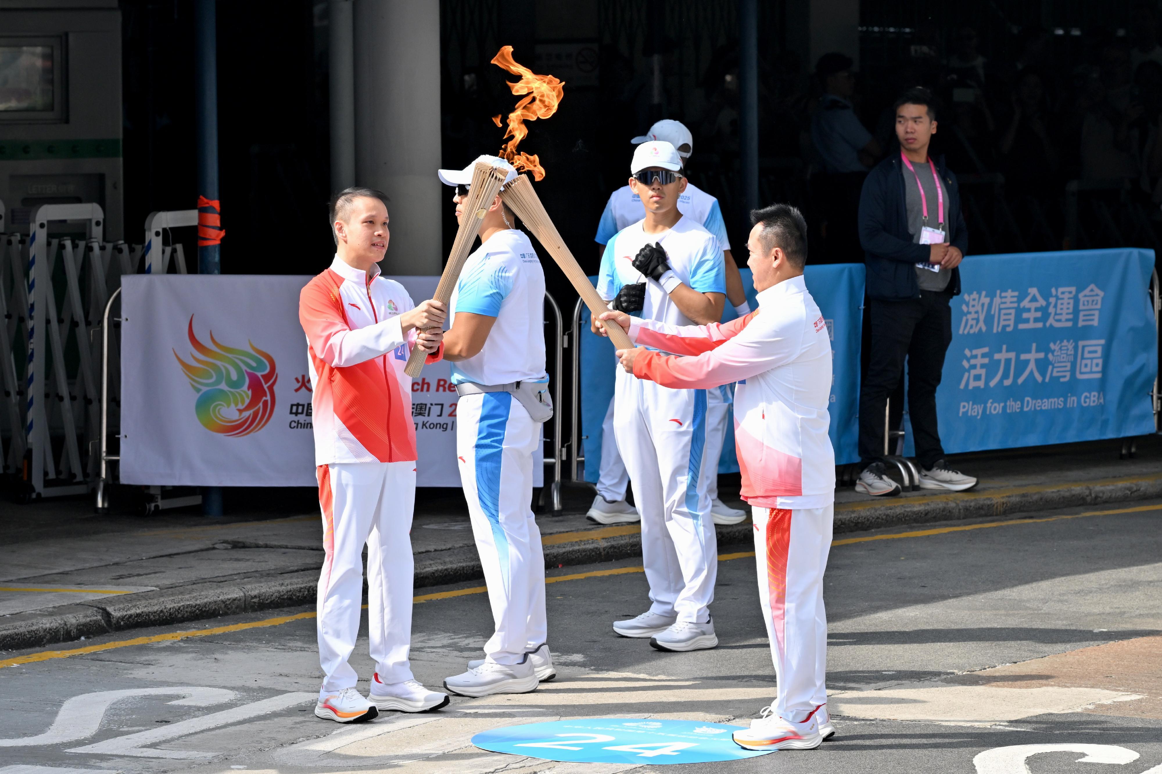 李靜（右）把火種傳給楊晉瑋（左）。