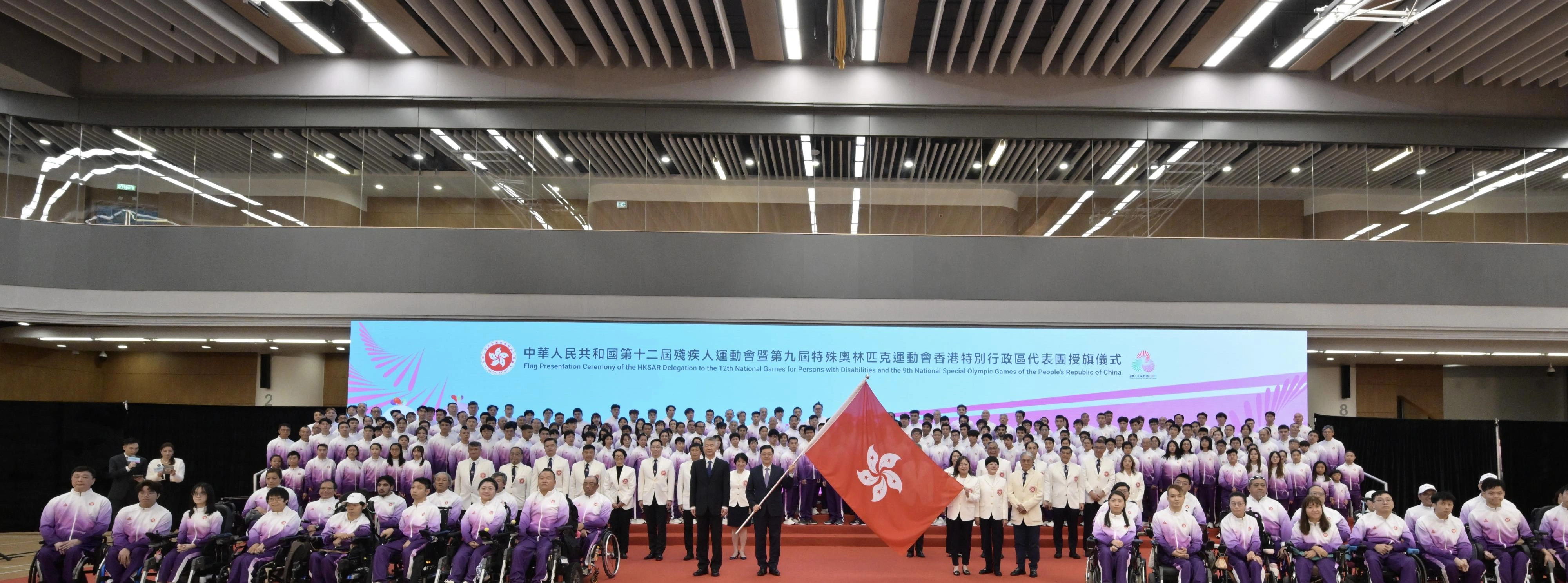 The Chief Executive, Mr John Lee, attended the flag presentation ceremony for the Hong Kong Special Administrative Region (HKSAR) Delegation to the 12th National Games for Persons with Disabilities and the 9th National Special Olympic Games of the People’s Republic of China on November 24. Photo shows Mr Lee (third row, second left), accompanied by Deputy Director of the Liaison Office of the Central People’s Government in the HKSAR, Mr Sun Shangwu (third row, first left), presenting the HKSAR regional flag to the Secretary for Culture, Sports and Tourism and Head of the Delegation, Miss Rosanna Law (third row, third right); the President of the China Hong Kong Paralympic Committee and Chairman of the Organising Committee of the Delegation, Mrs Jenny Fung (third row, second right); and the President of the Sports Federation & Olympic Committee of Hong Kong, China and Chairman of the Organising Committee of the Delegation, Mr Timothy Fok (third row, first right).