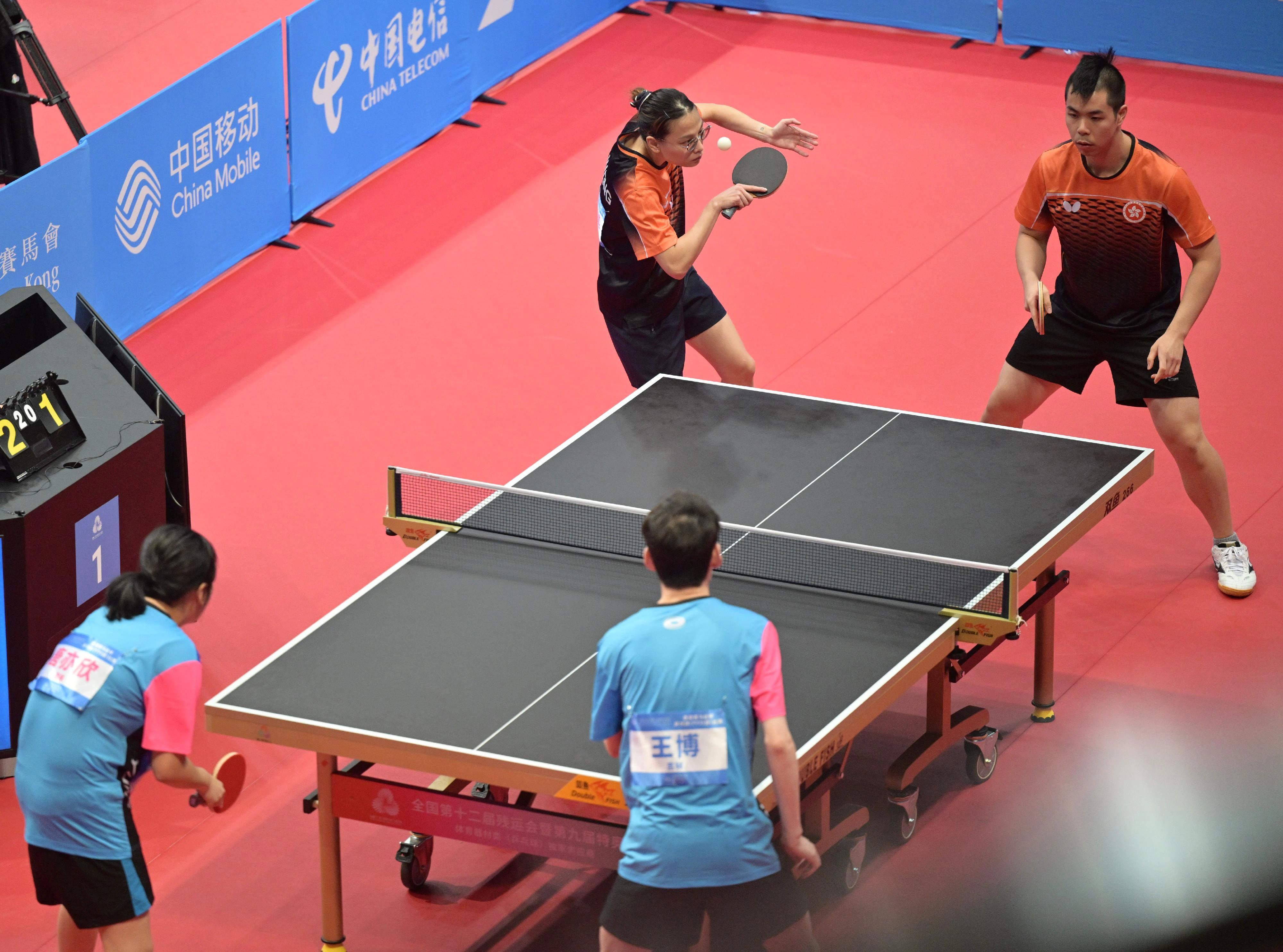 The Hong Kong Jockey Club Trophy para table tennis (TT11) competition of the 12th National Games for Persons with Disabilities and the 9th National Special Olympic Games was held on December 13 at Tsuen Wan Sports Centre. Photo shows athletes competing in the mixed doubles event.