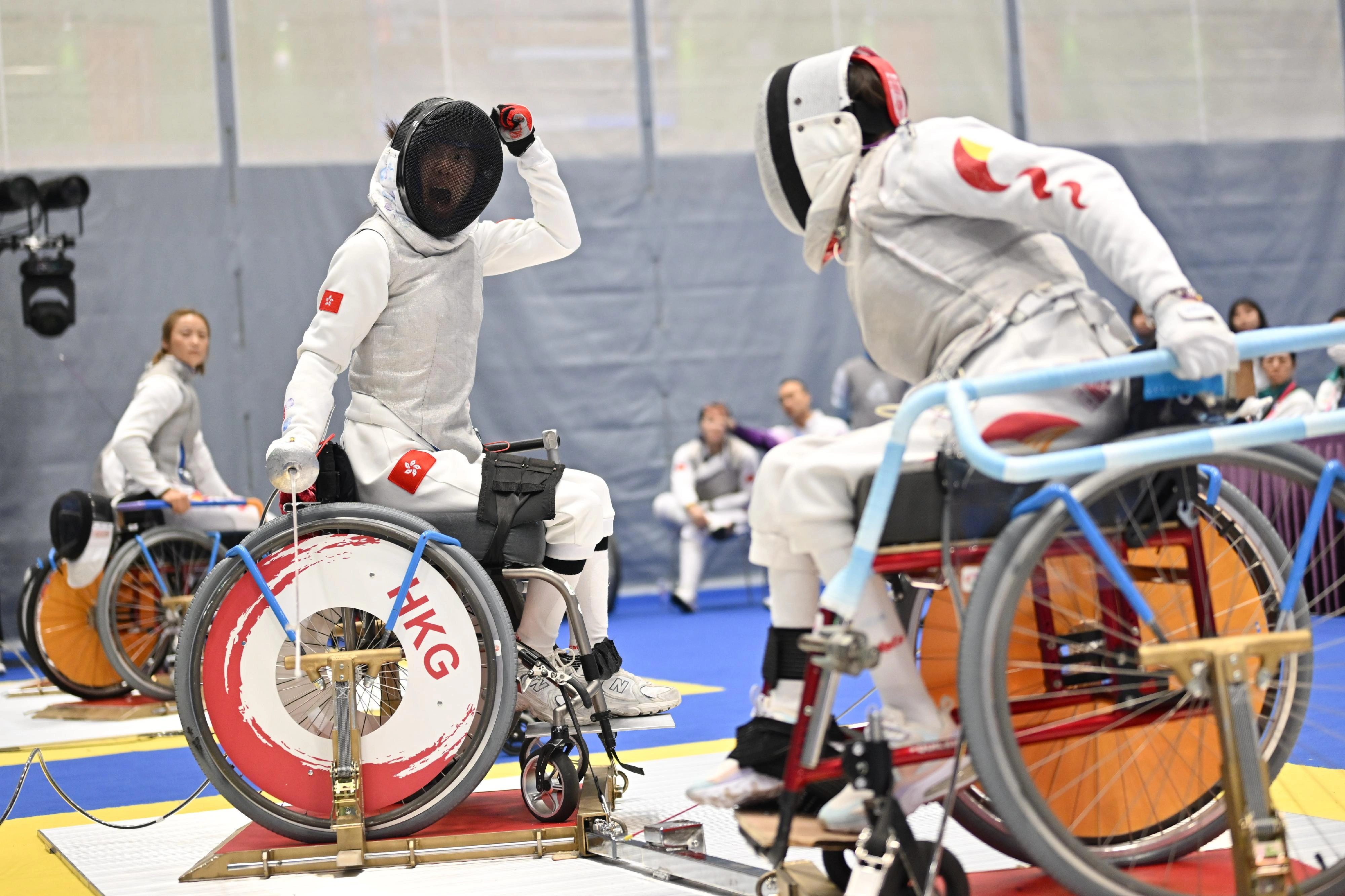 The women's foil team of the Hong Kong Jockey Club Trophy wheelchair fencing competition of the 12th National Games for Persons with Disabilities and the 9th National Special Olympic Games was held at Ma On Shan Sports Centre on December 10. Photo shows athletes competing in the event.