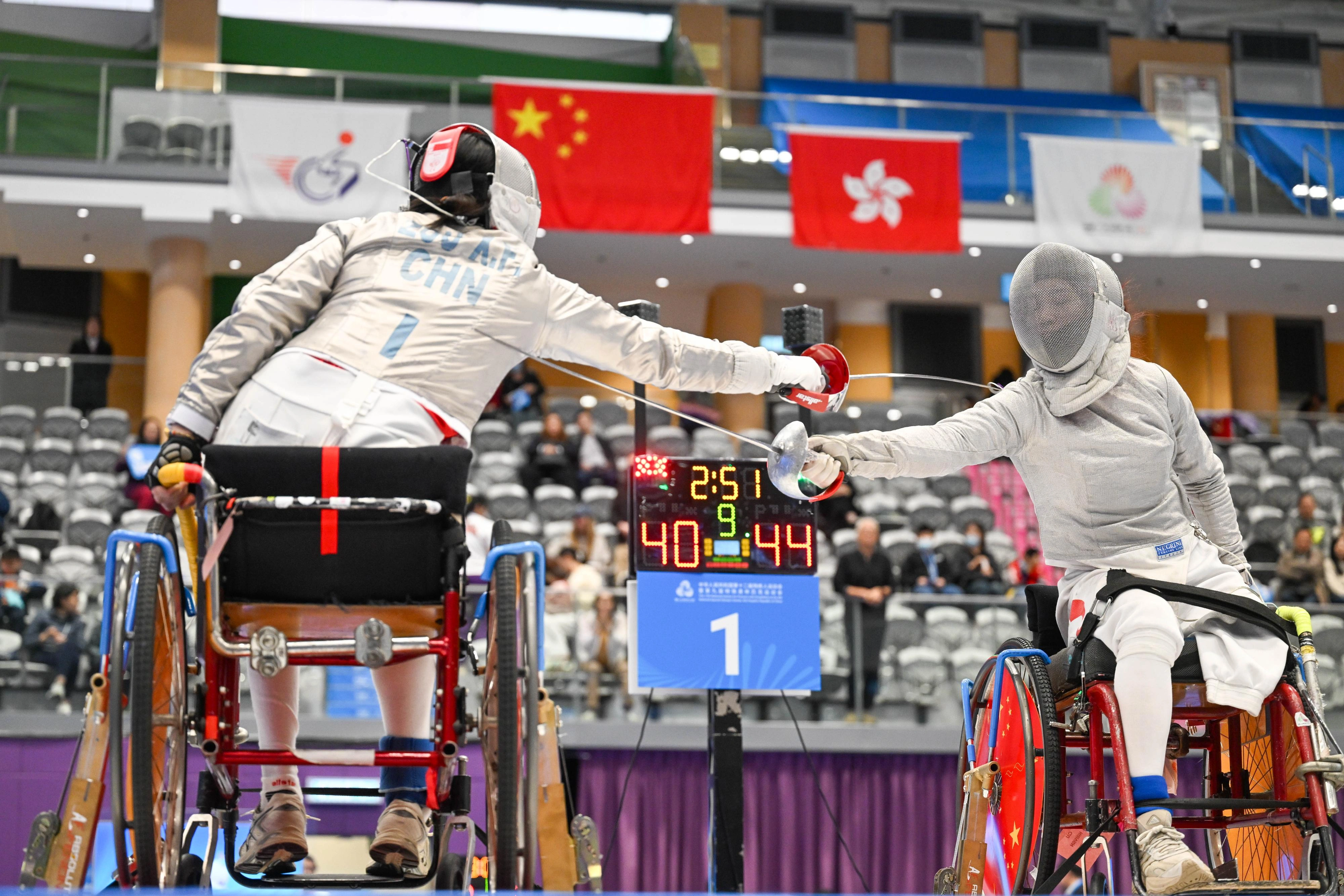 The women's sabre team of the Hong Kong Jockey Club Trophy wheelchair fencing competition of the 12th National Games for Persons with Disabilities and the 9th National Special Olympic Games was held at Ma On Shan Sports Centre on December 14. Photo shows athletes competing in the event.
